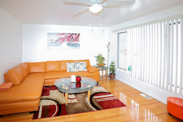 living room with hardwood / wood-style flooring and ceiling fan