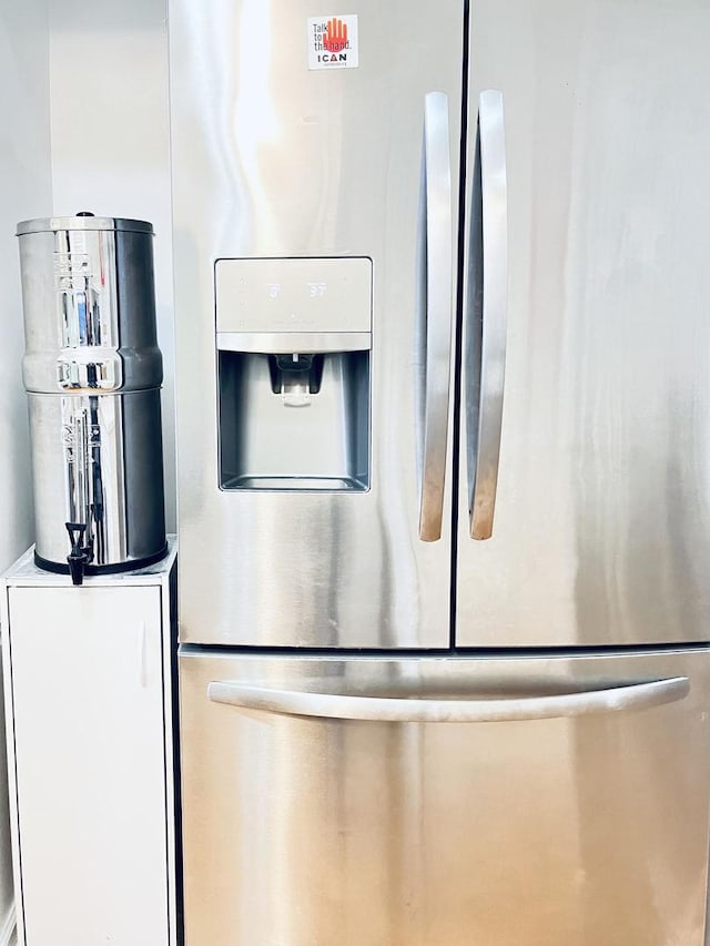 interior details featuring stainless steel fridge with ice dispenser