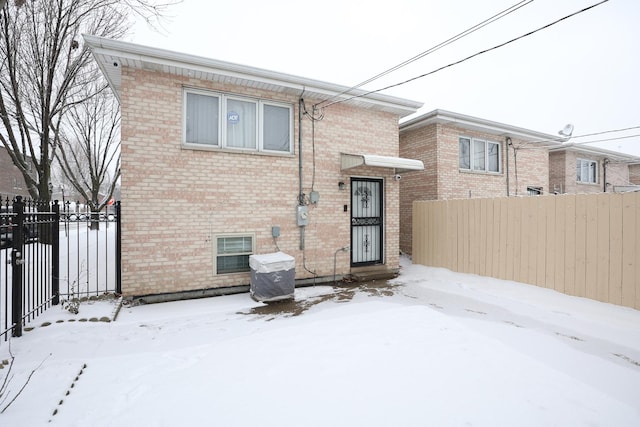 view of snow covered rear of property