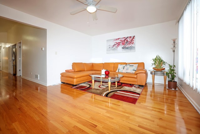 living room with ceiling fan and hardwood / wood-style floors