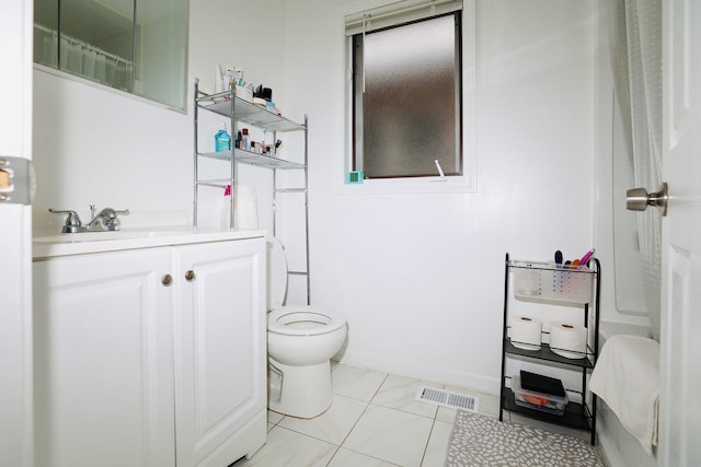 bathroom featuring toilet, vanity, and tile patterned floors