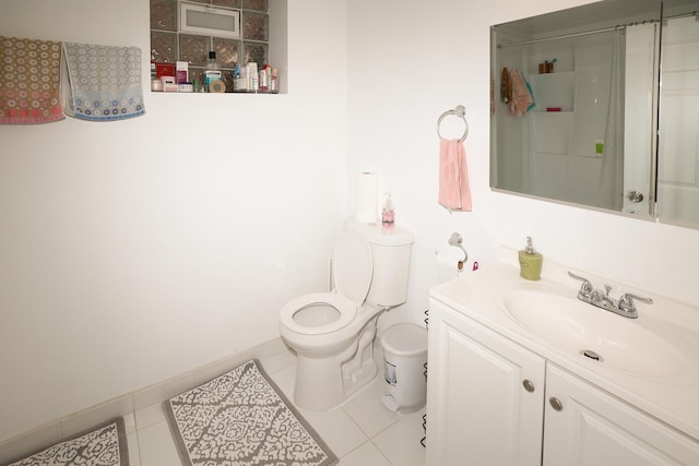 bathroom featuring toilet, tile patterned floors, vanity, and a shower with shower door