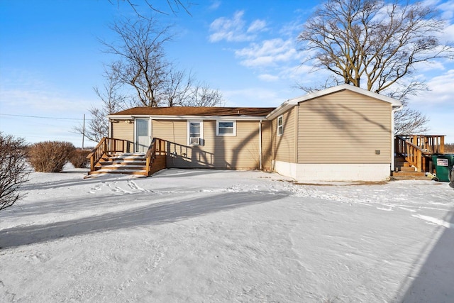 snow covered back of property with cooling unit