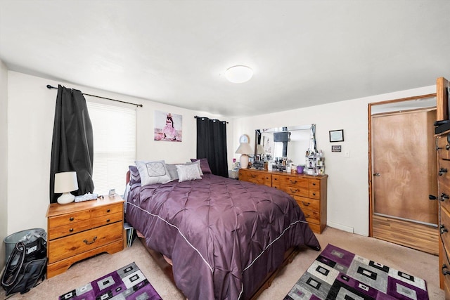 carpeted bedroom featuring multiple windows