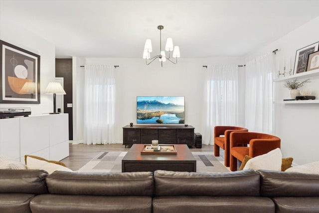 living room featuring a chandelier and light hardwood / wood-style floors