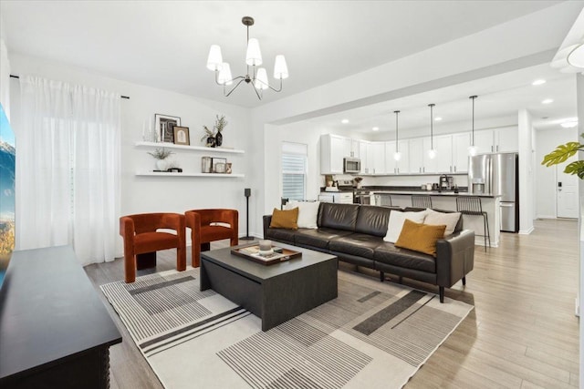 living room featuring light hardwood / wood-style flooring and a chandelier