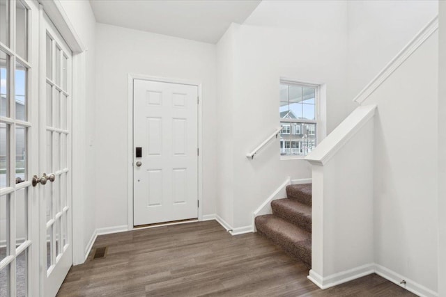 entryway with dark hardwood / wood-style flooring and french doors