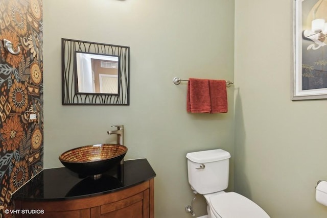 bathroom featuring toilet and vanity