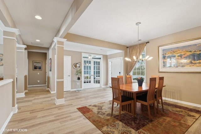 dining area featuring baseboards, light wood finished floors, recessed lighting, french doors, and a notable chandelier