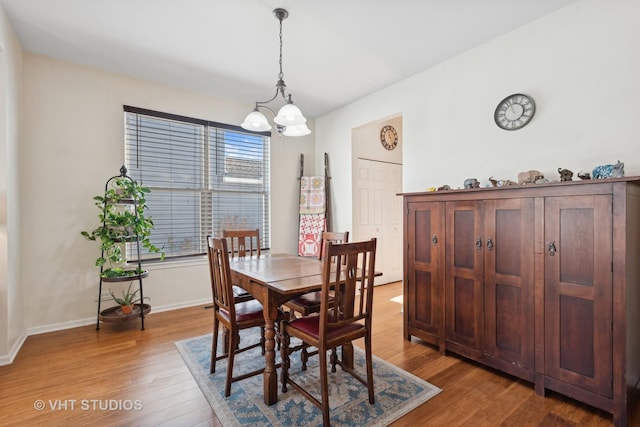 dining area featuring an inviting chandelier and light wood-type flooring