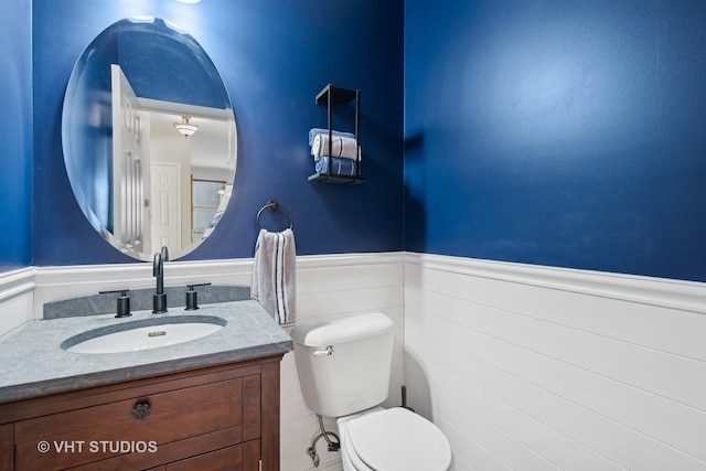 bathroom featuring toilet and vanity