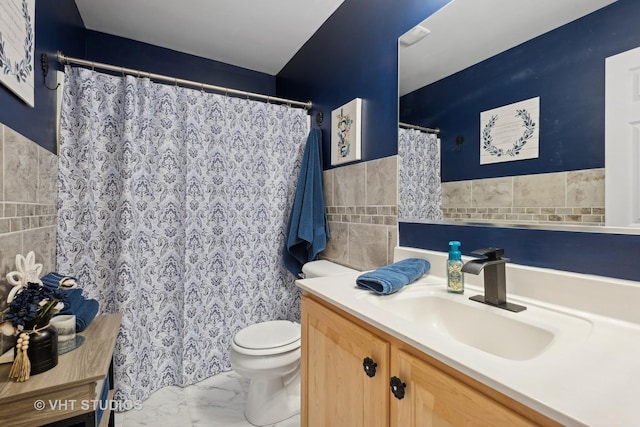 bathroom featuring tile walls, toilet, and vanity