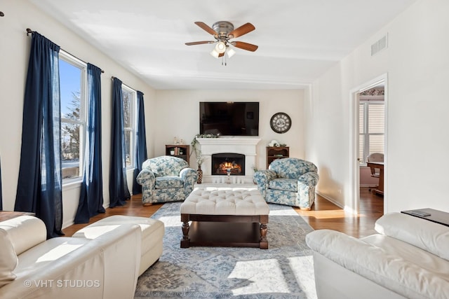 living room with ceiling fan and light hardwood / wood-style floors