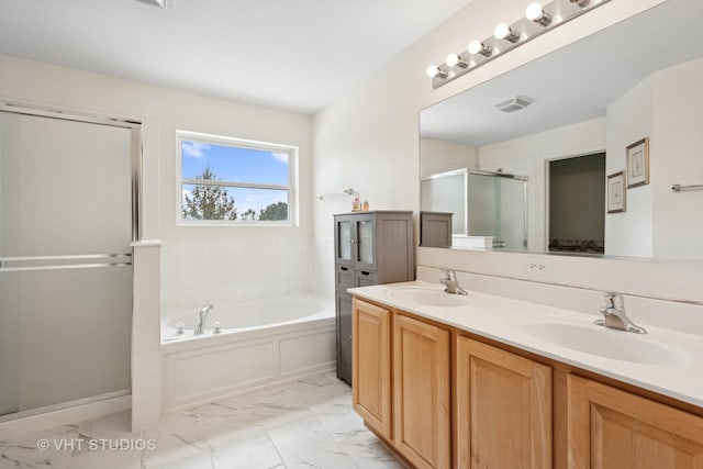 bathroom featuring vanity and shower with separate bathtub