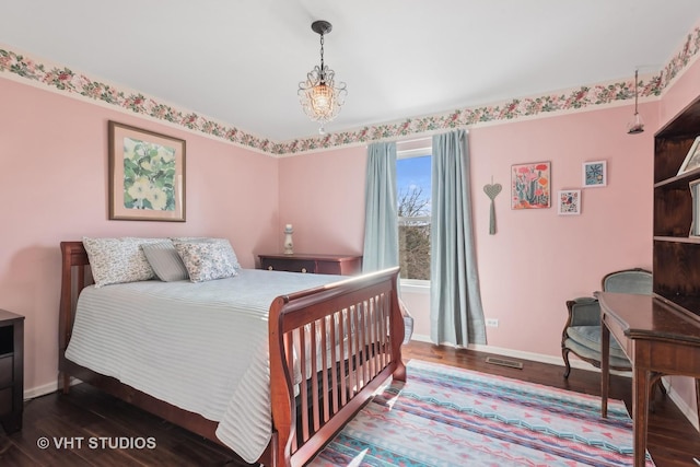 bedroom featuring a chandelier and hardwood / wood-style floors