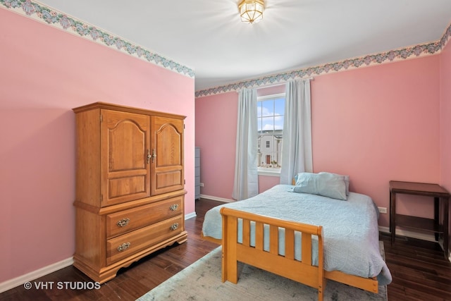 bedroom with dark hardwood / wood-style flooring