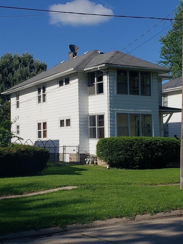 view of side of home featuring a yard