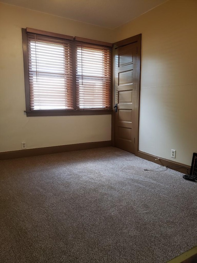 unfurnished room with carpet flooring and a wealth of natural light