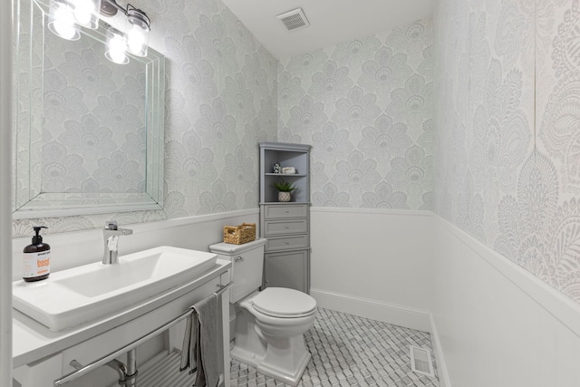 bathroom featuring tile patterned floors, toilet, and vanity