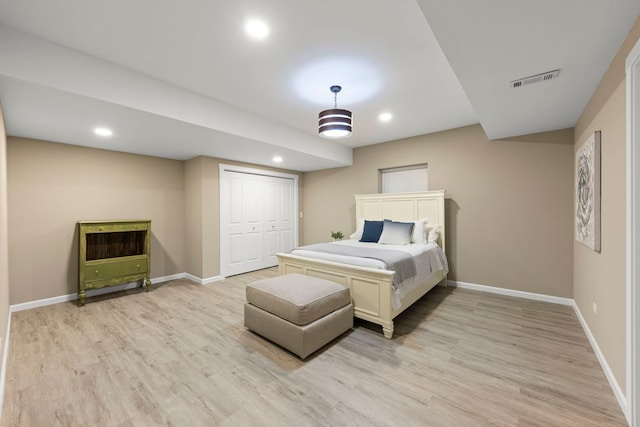 bedroom with a closet and light hardwood / wood-style flooring