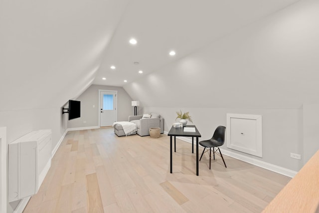 additional living space with lofted ceiling and light wood-type flooring