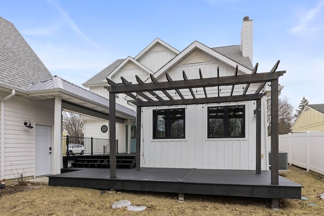 rear view of house with cooling unit, a pergola, and a deck