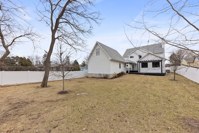 rear view of property with a yard