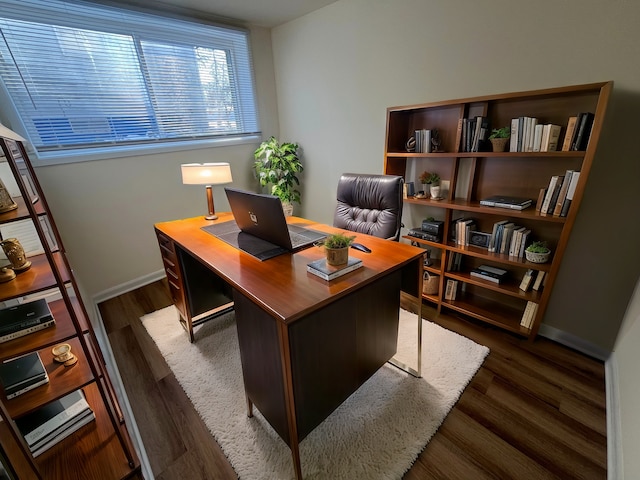 home office with dark wood-type flooring