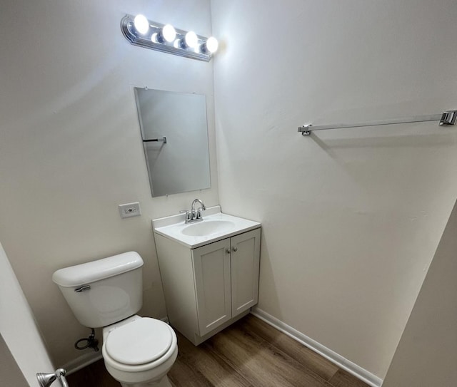 bathroom featuring hardwood / wood-style floors, vanity, and toilet