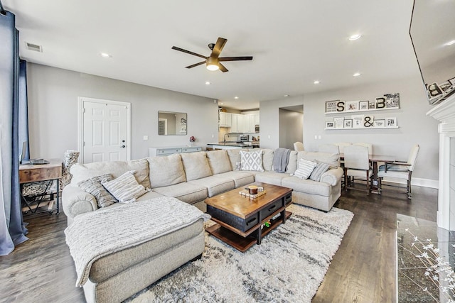 living room with ceiling fan and dark hardwood / wood-style floors