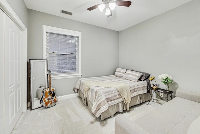 bedroom featuring light carpet, a closet, and ceiling fan