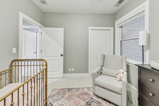 bedroom with light colored carpet and a crib