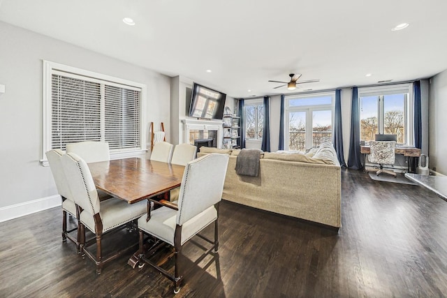 dining space featuring ceiling fan and dark wood-type flooring