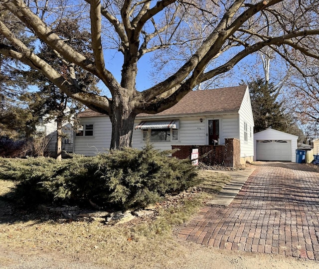 view of front of property featuring a garage and an outdoor structure