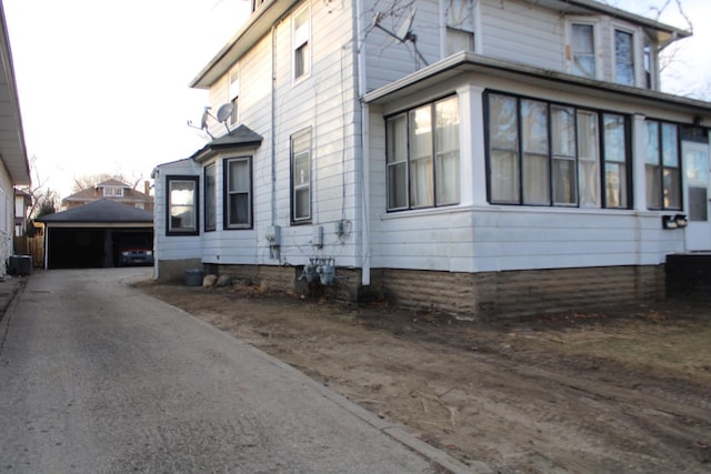 view of property exterior with an outbuilding and a garage