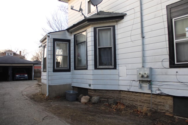 view of side of property featuring a garage and an outdoor structure