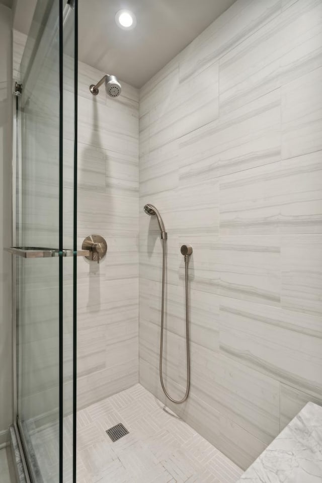 bathroom with a tile shower