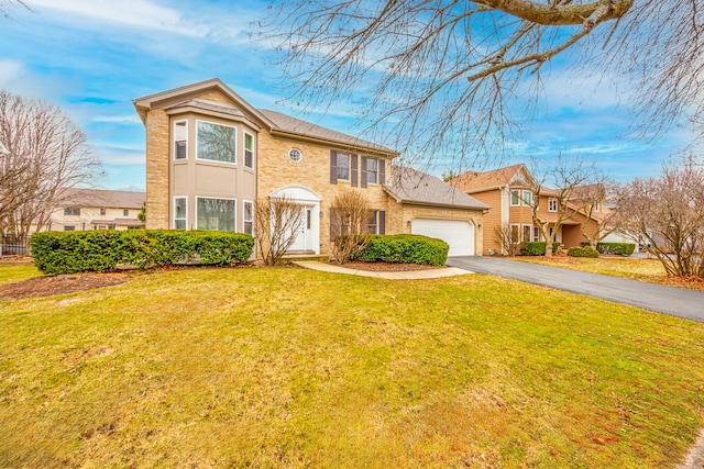 view of front of house with a garage and a front lawn