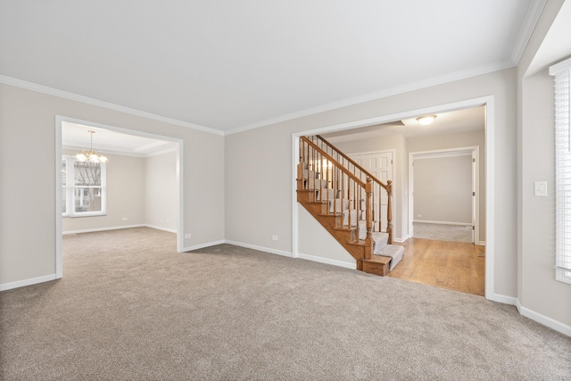 unfurnished room featuring light colored carpet, crown molding, and a chandelier