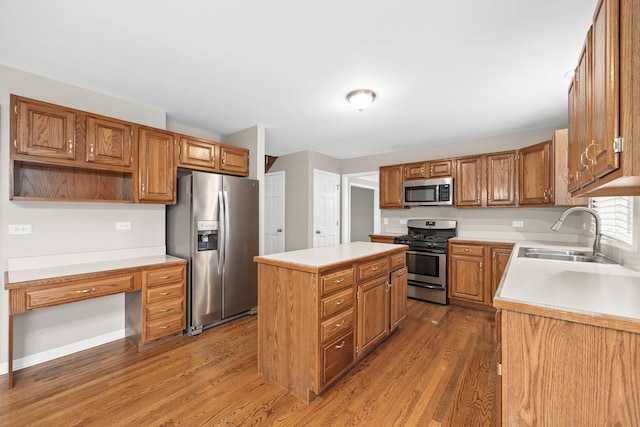 kitchen with a center island, sink, stainless steel appliances, and dark wood-type flooring