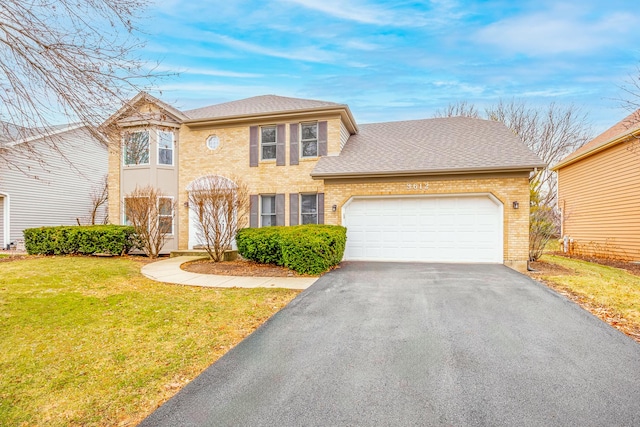 view of front of property with a front yard and a garage