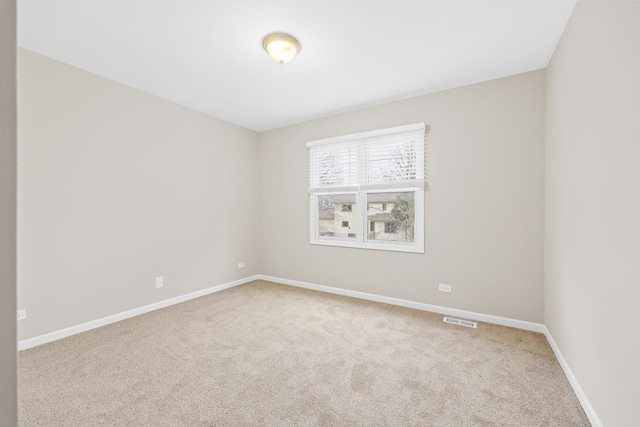 empty room featuring light colored carpet