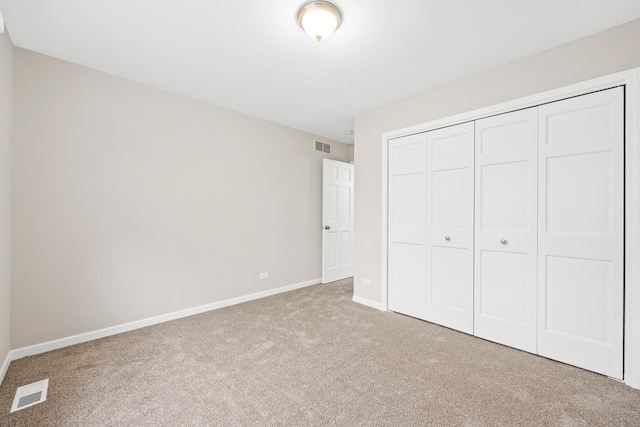 unfurnished bedroom with a closet and carpet floors