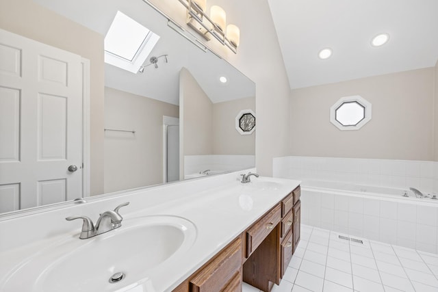 bathroom with tile patterned flooring, vanity, independent shower and bath, and vaulted ceiling with skylight