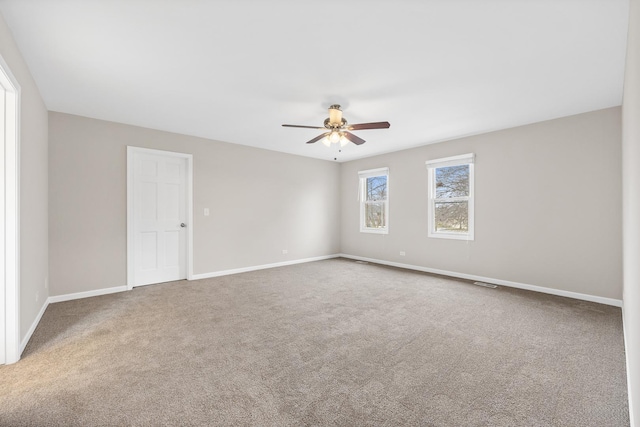 empty room featuring carpet and ceiling fan