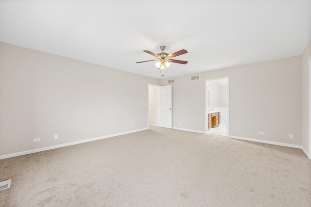 carpeted spare room featuring ceiling fan