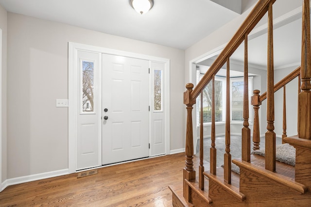 foyer entrance with hardwood / wood-style flooring