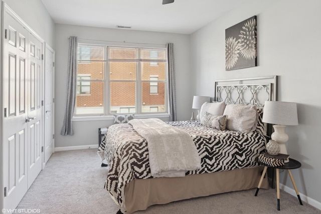 carpeted bedroom with a closet and multiple windows