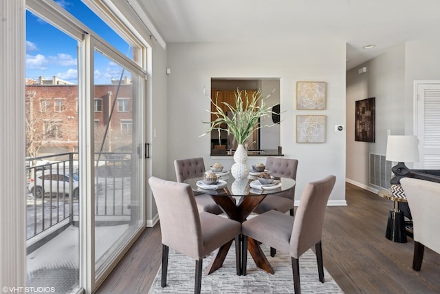 dining space with dark hardwood / wood-style floors