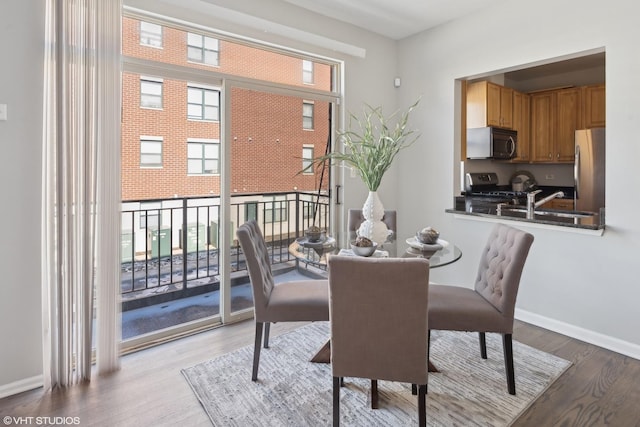 dining room featuring light hardwood / wood-style flooring and sink